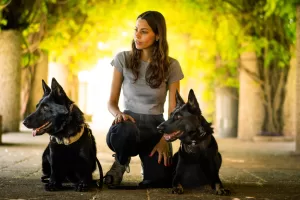 Woman with two personal protection dogs on either side