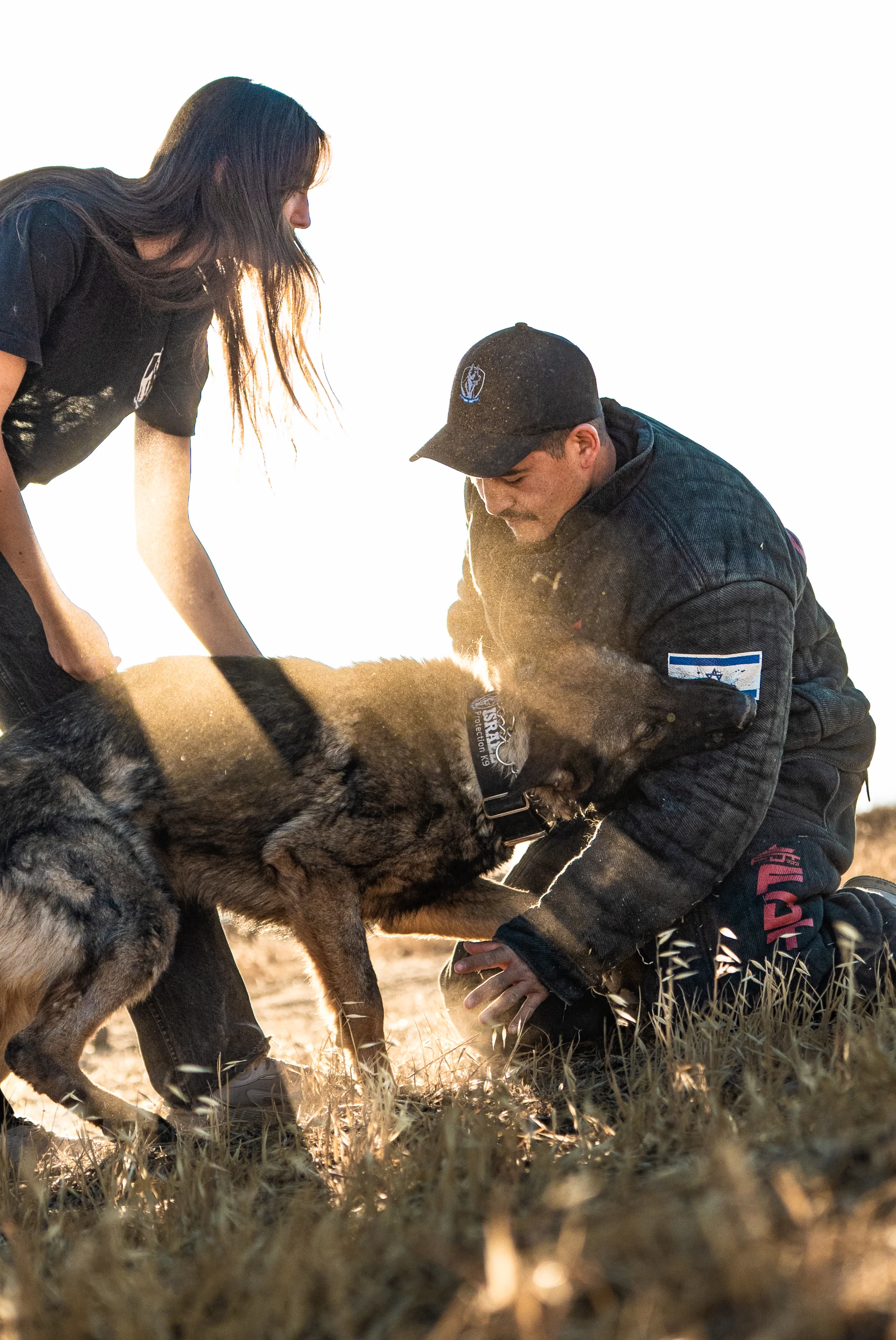 Israel Protection K9 trainer interacting with a German Shepherd protection dog during training.