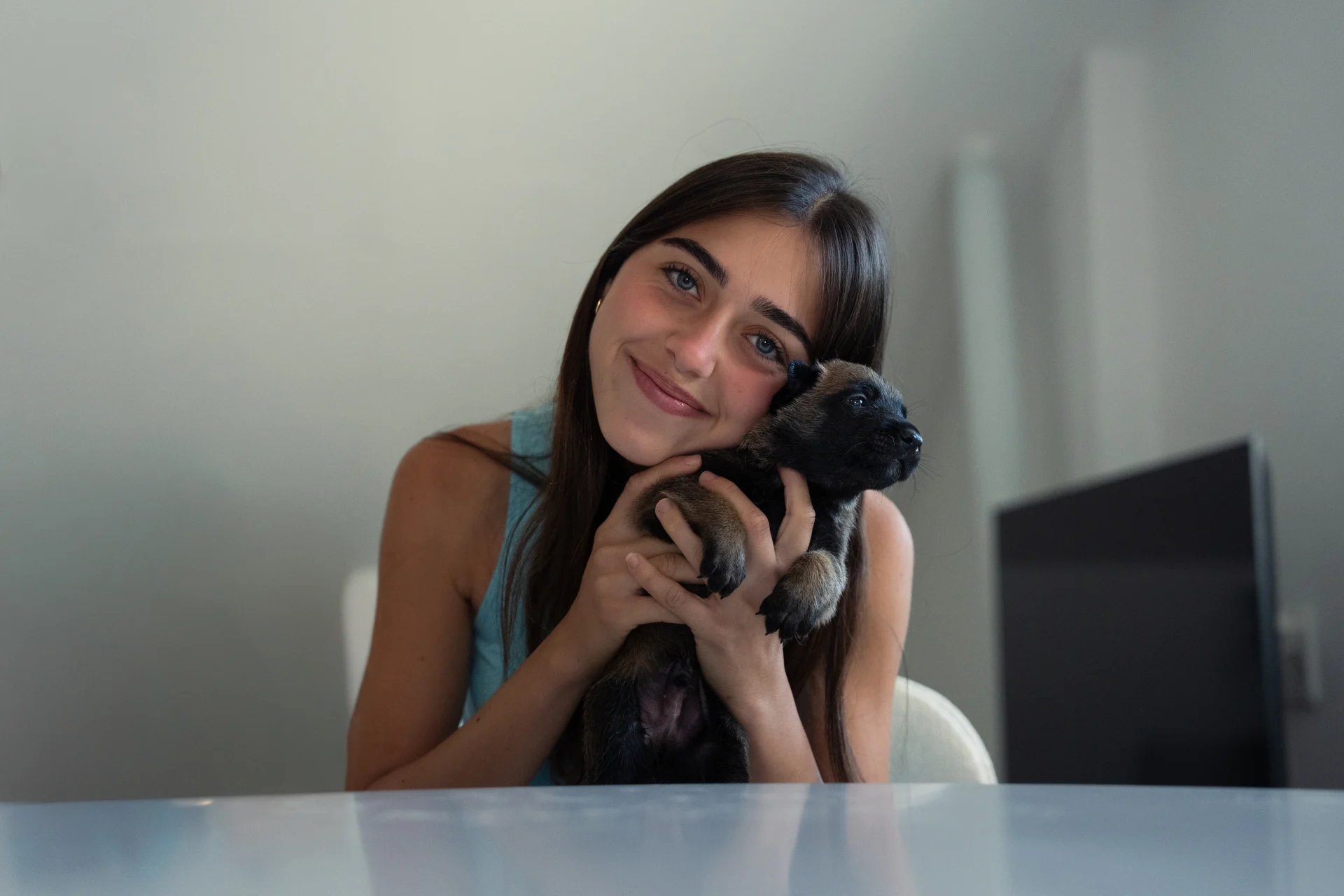 Black protection dog puppy and young woman, family bred for protection.