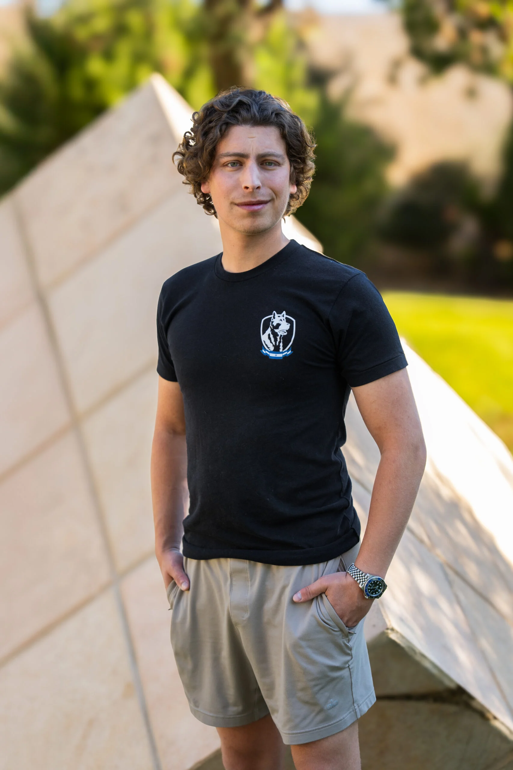 Arik Deri, Israel Protection K9 trainer, in company logo t-shirt and casual attire.